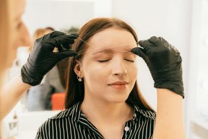 Eyebrow threading in a modern salon setting.